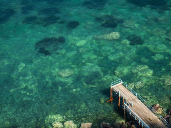 High angle view of pier by blue sea at sorrento on sunny day