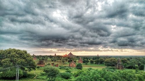 Scenic view of field against cloudy sky