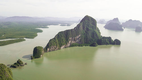 Scenic view of rocks in sea against sky