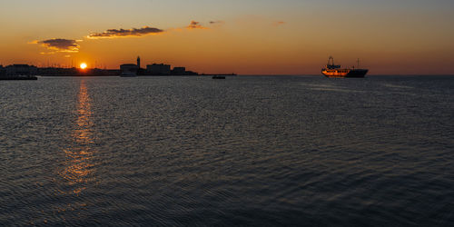 Sunset from the audace pier of trieste. colors of fire on the water. italy