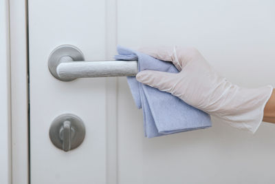 Cropped hand of woman with closed door