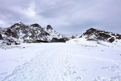 Scenic view of snow covered mountains against sky