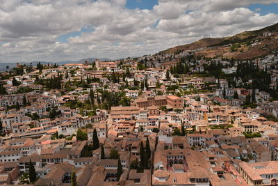 Cityscape against cloudy sky
