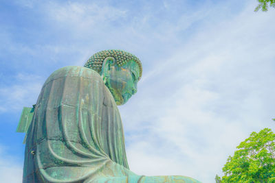 Low angle view of statue against cloudy sky