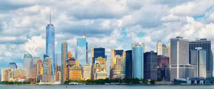 View of skyscrapers against cloudy sky