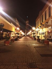 Illuminated city street at night