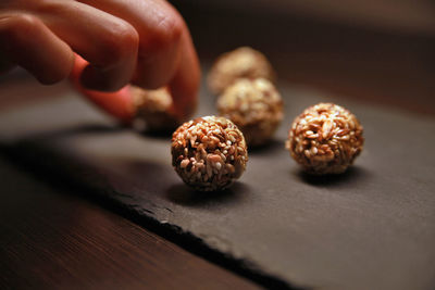 Cropped hand having food on table