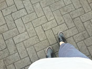 High angle view of man standing on footpath