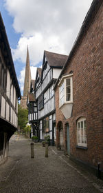 Residential buildings in town against sky