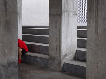 Person sitting on steps in old building