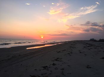 Scenic view of beach against sky during sunset