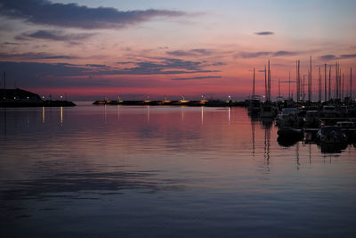 Sailboats in marina at sunset