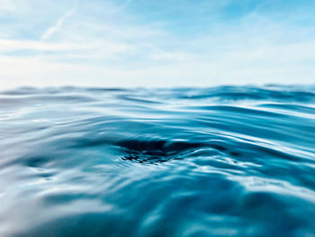 Close-up of rippled water in swimming pool against sky