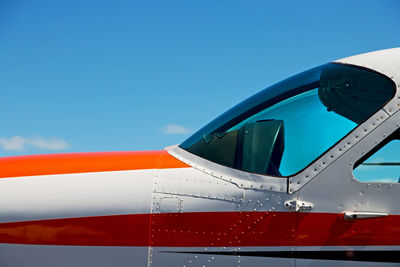 Close-up of airplane wing against clear blue sky