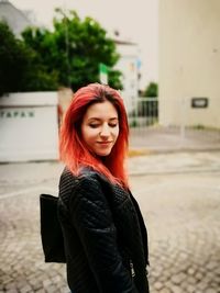 Portrait of beautiful young woman standing outdoors