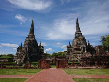 Old temple building against cloudy sky