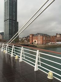 Empty road amidst buildings in city against sky