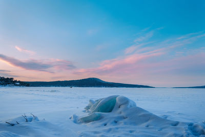 Scenic view of frozen sea against sky during sunset