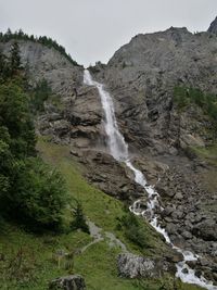 Scenic view of waterfall against sky