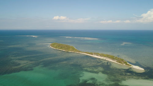 Tropical island with white sandy beach, palm trees. aerial view of tanduyong island 