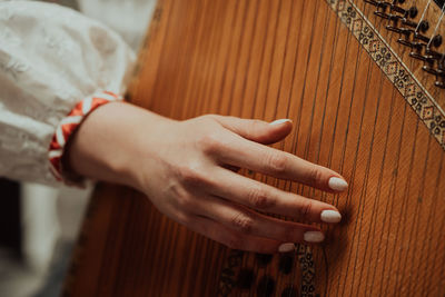 Midsection of woman playing guitar