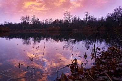 Scenic view of lake against sky at sunset