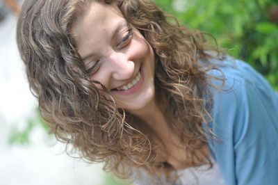 Beautiful young woman with wavy hair looking away