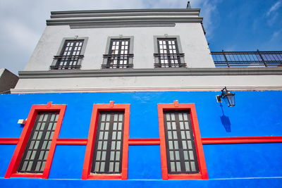 Low angle view of buildings against blue sky