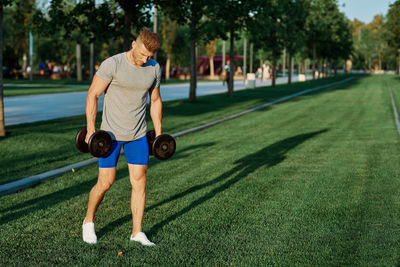 Full length of man skateboarding on grass