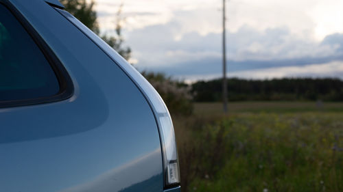 Close-up of car window on field