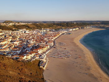 High angle view of townscape by sea against sky