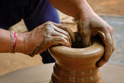 Midsection of man working at workshop