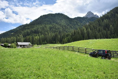 Scenic view of land and mountains against sky