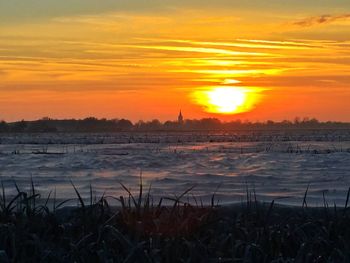 Scenic view of field against sky during sunset