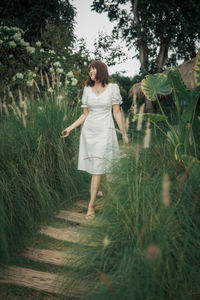 Rear view of woman standing on field