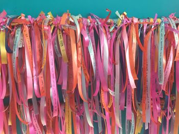 Close-up of multi colored flags hanging for sale