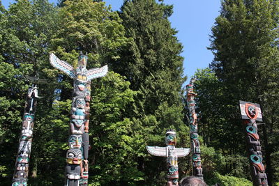 Low angle view of statue against trees