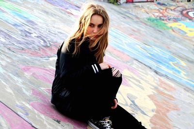 High angle view of young woman sitting on floor