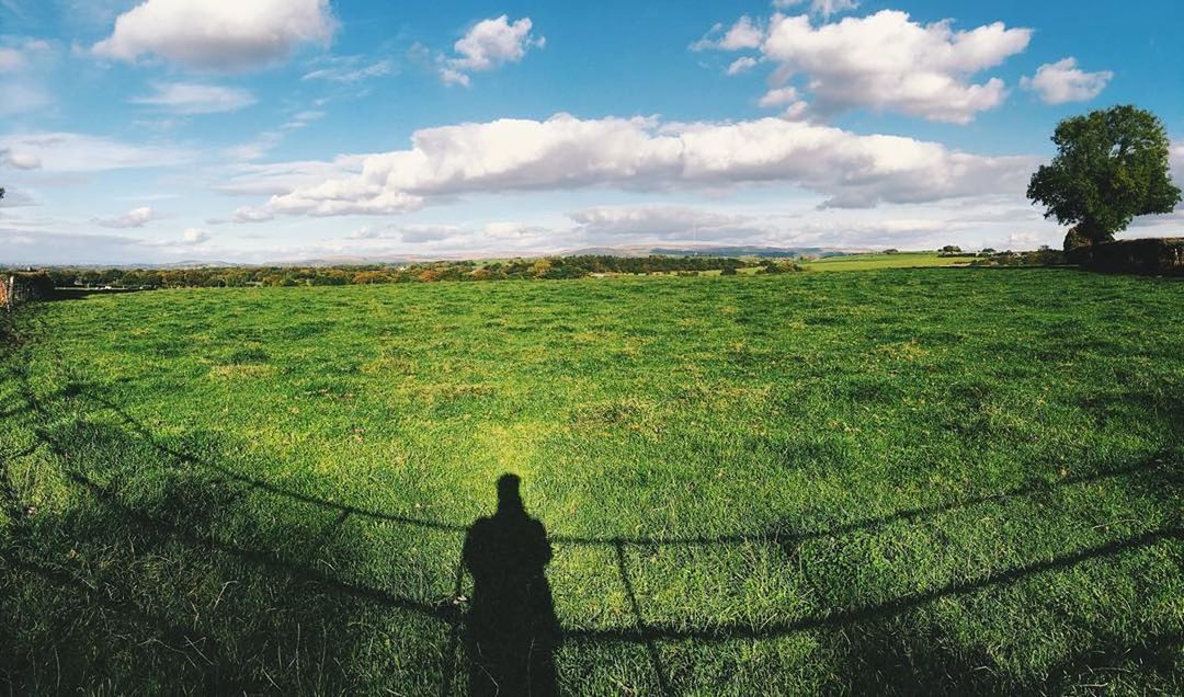 field, landscape, agriculture, nature, beauty in nature, farm, scenics, growth, tranquility, green color, tranquil scene, sky, cloud - sky, cultivated land, grass, rural scene, outdoors, day, tree, real people, rice paddy, one person, people