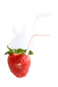 Close-up of strawberry over white background