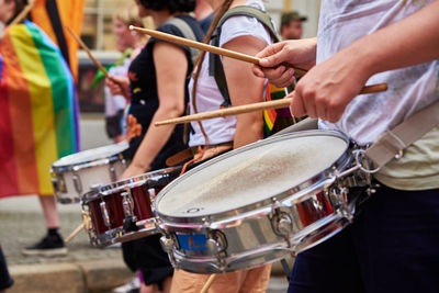 People with drums in street at demonstration in city