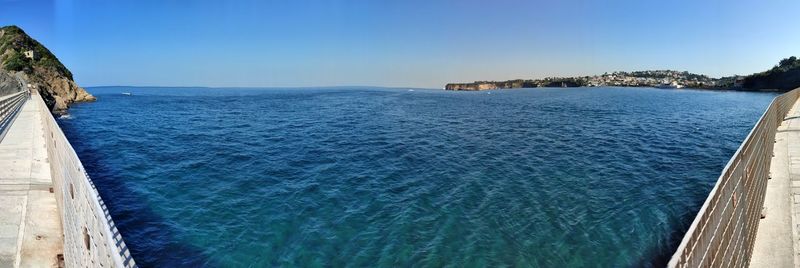 Scenic view of sea against clear blue sky