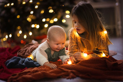 Baby is 6 months crying and the elder sister is comforting him, concept holidays 