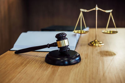 Close-up of gavel with hammer and weight on table