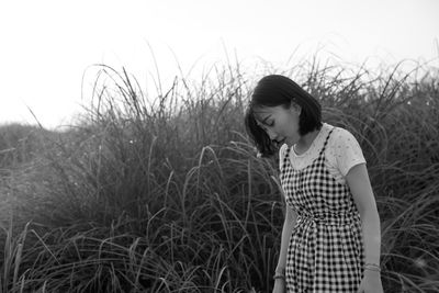 Woman standing against plants