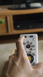 Close-up of hand holding camera at home