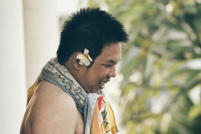 Side view of cheerful overweight young man outdoors