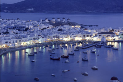 High angle view of boats moored in sea at night