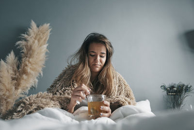 Portrait of young woman drinking glass