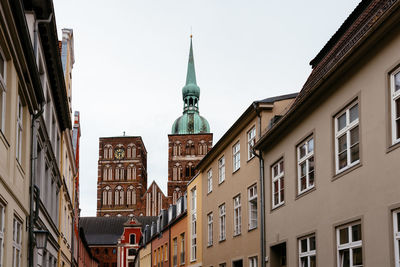 Traditional colorful houses and church tower in the old town of stralsund.